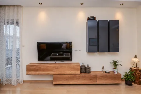 Living room with a TV unit and hanging cabinets. - image 5