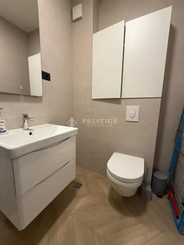 Modern bathroom with a sink and toilet.