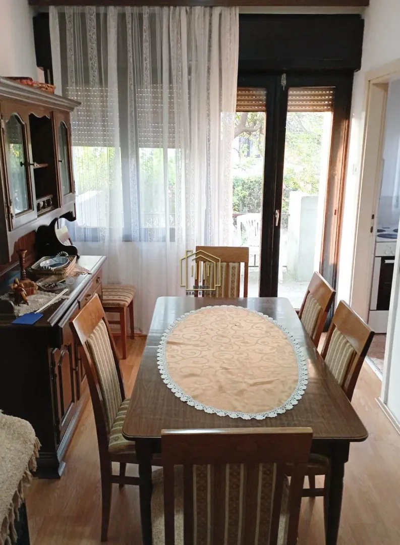 Dining room with a wooden table, chairs, and a cabinet.