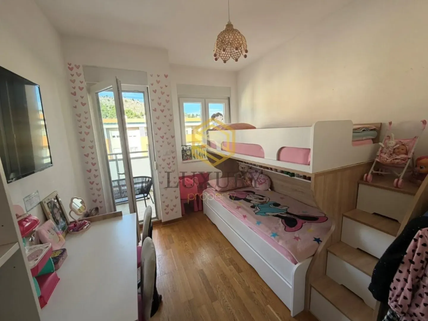 Children's bedroom with a bunk bed and a desk.