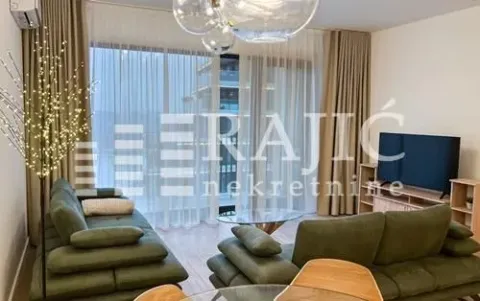 Spacious and bright living room with a sofa and large windows. - image 2