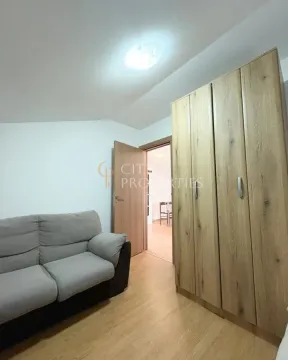 Small living room with a sofa and a wooden wardrobe. - image 12