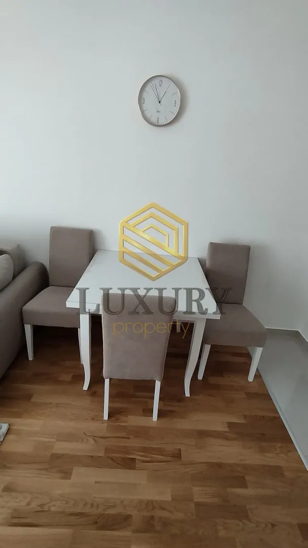 Dining table with four chairs in a bright interior.