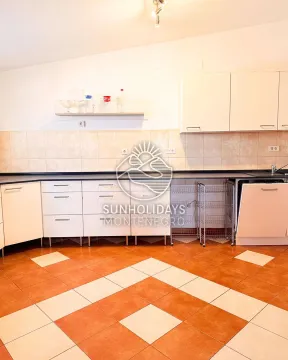 View of a kitchen section with white cabinetry and tiled flooring. - image 5