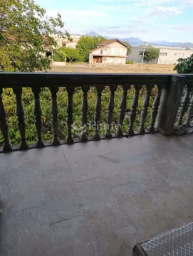 Balcony with a stone balustrade and a view of the surrounding neighborhood and hills. - image 7