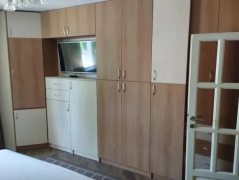 Bedroom with built-in wardrobes and a wall-mounted TV. - image 11