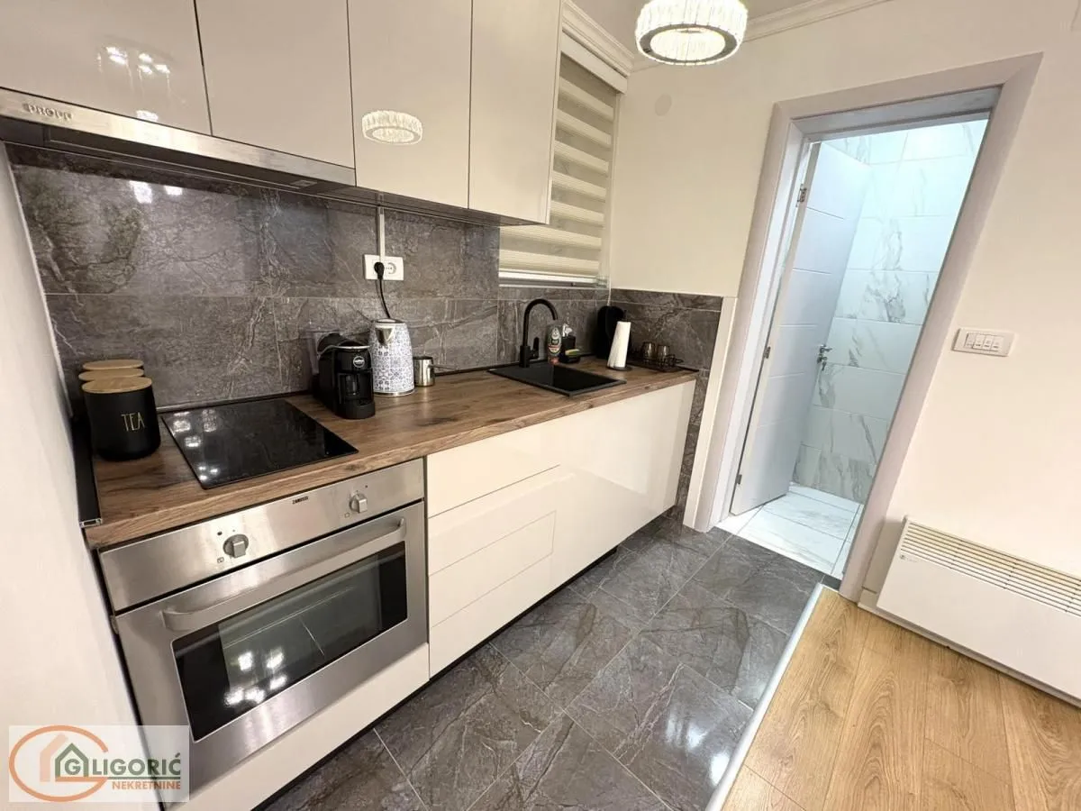 Modern kitchen with built-in oven, sink, and countertops.