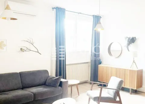 Bright living room with a sofa set and a wooden dresser. - image 14