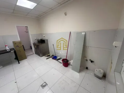 An empty, unfinished room with tiled floors and walls. - image 2