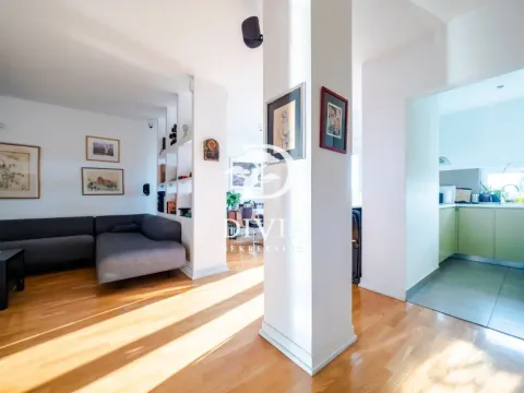 Living room with sofa and view towards the kitchen and dining area. - image 15