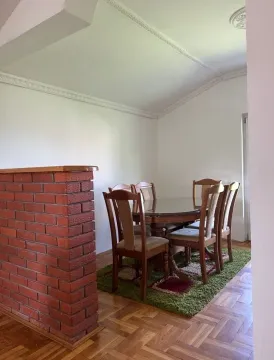 Dining room with a wooden table, chairs, and parquet flooring. - image 4
