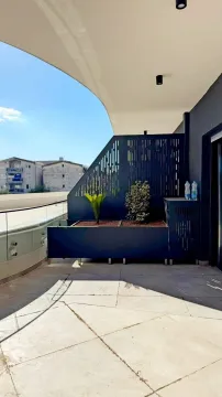Spacious modern terrace with planters and a view of surrounding buildings. - image 5