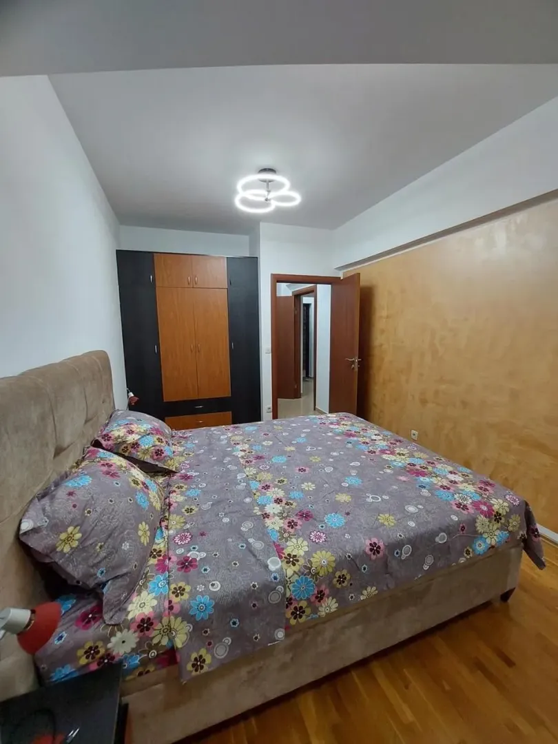 Spacious bedroom with a large double bed and wardrobe.