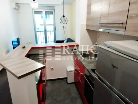 Small kitchen with a bar counter and dining area. - image 8