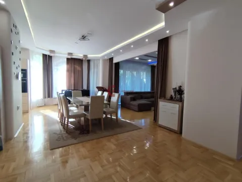 Spacious living room with dining area and parquet flooring. - image 21