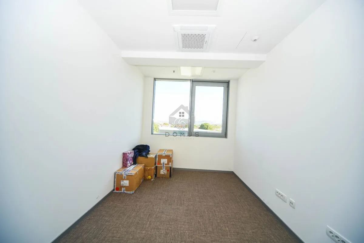 Empty bright room with boxes on the floor and a window.