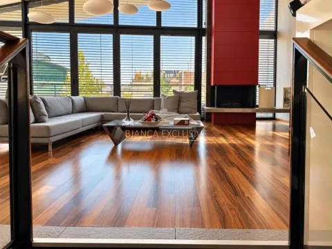 Spacious living room with a sectional sofa, fireplace, and large glass surfaces. - image 11