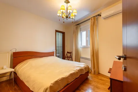 Furnished bedroom with a double bed, a window, and a view into the bathroom. - image 16