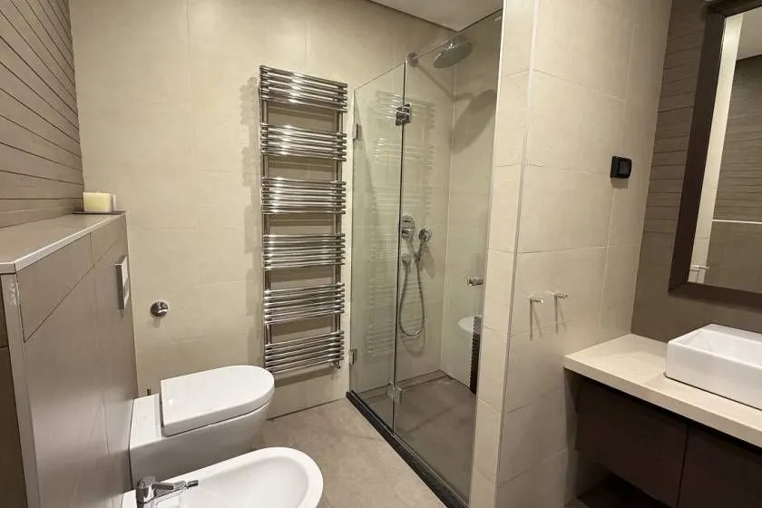 Modern bathroom equipped with a shower cabin, washbasin, and sanitary fixtures.