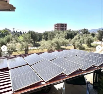 Solar panels installed on the roof of an outbuilding with a view of the surrounding greenery. - image 8