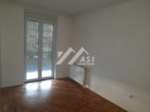 Empty room with parquet flooring and balcony doors. - image 10