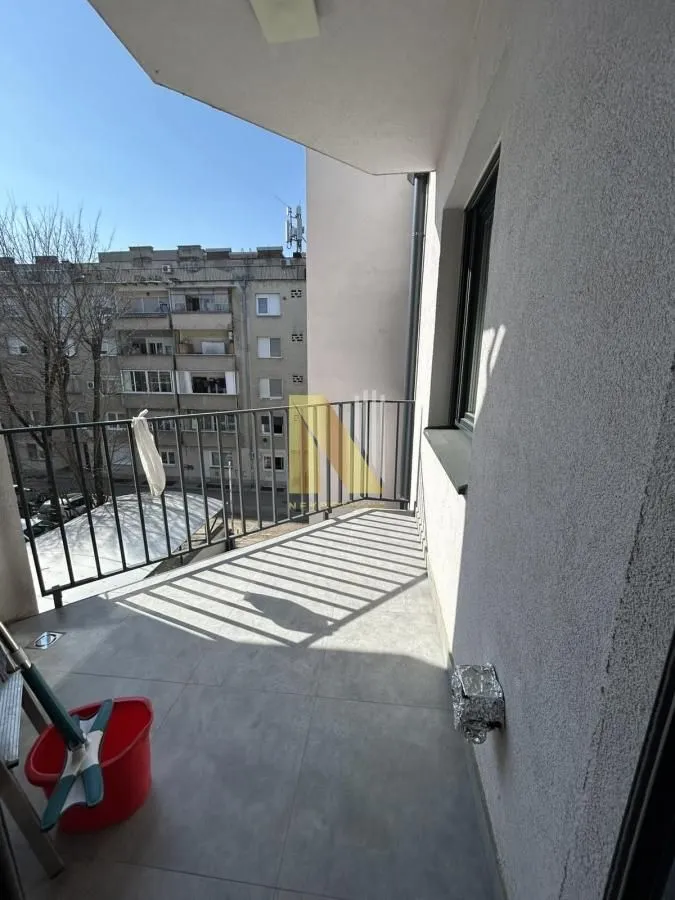 Unfurnished balcony with metal railing and city view.