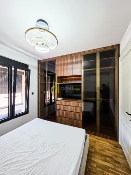 Furnished bedroom with a double bed and a large built-in wardrobe. - image 16