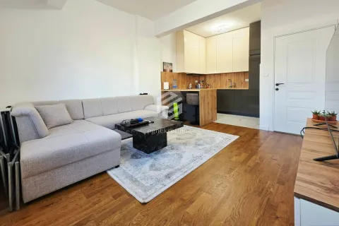 Living room with a sectional sofa and a view of the kitchen. - image 10