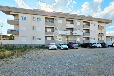 View of the exterior of the residential building with a parking lot in front. - image 2