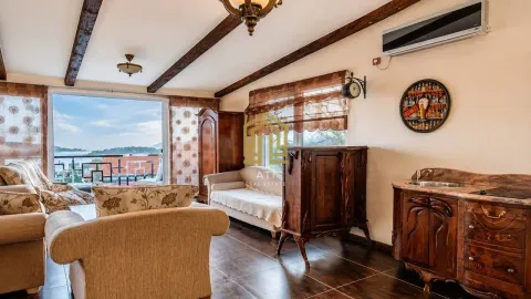 Living room with stylish wooden furniture and a sea view. - image 6