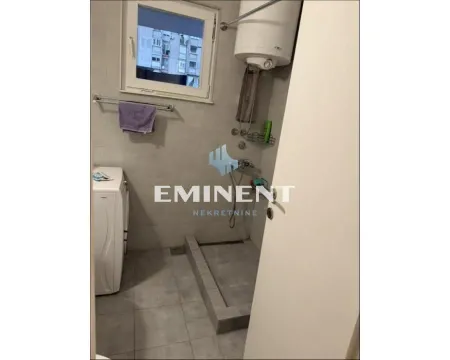 Smaller bathroom with a shower cabin and washing machine. - image 8