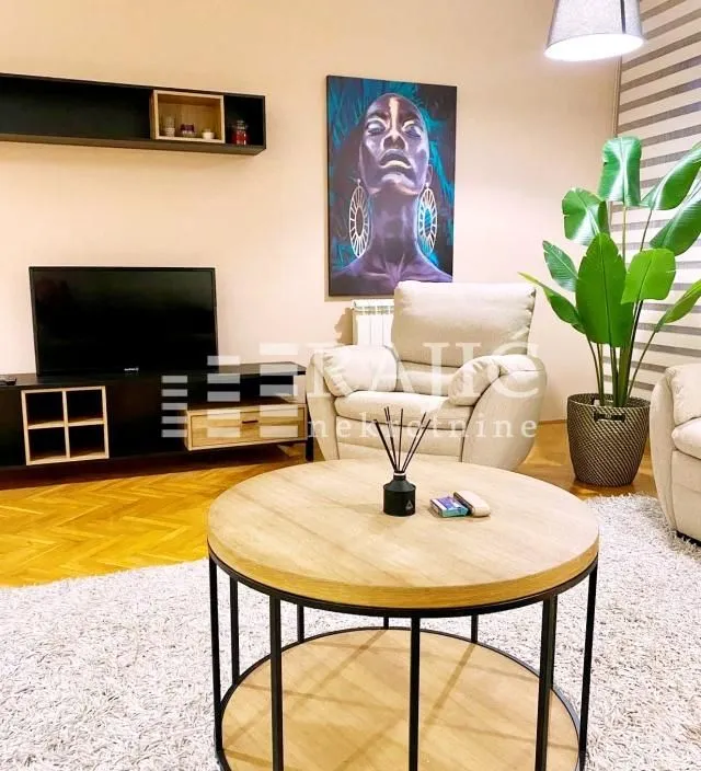 Living room with a sofa set, TV, and coffee table.