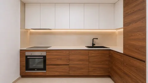 Modern kitchen with white upper cabinets and wooden lower cabinets. - image 2