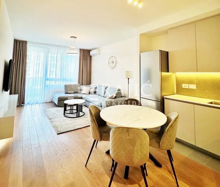 Modern living room with dining area and open-plan kitchen.
