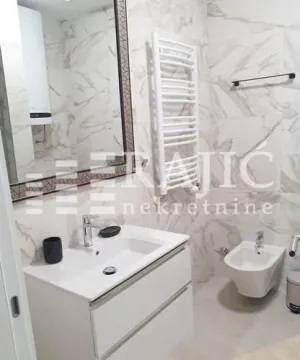 Modern bathroom equipped with a washbasin and bidet. - image 4