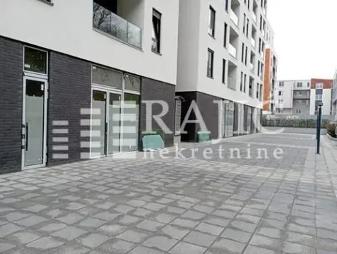 Exterior of a modern residential building with a paved courtyard. - image 8