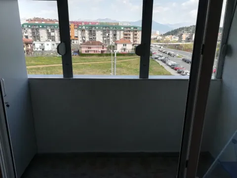 View from the enclosed balcony overlooking the neighborhood and surrounding buildings. - image 7