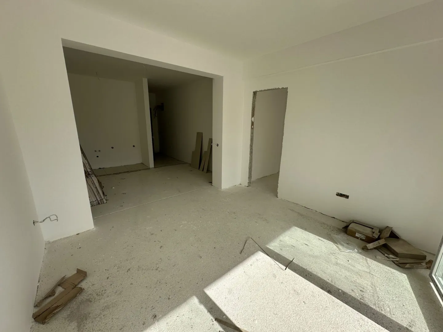 Empty room in an apartment under construction with white walls.