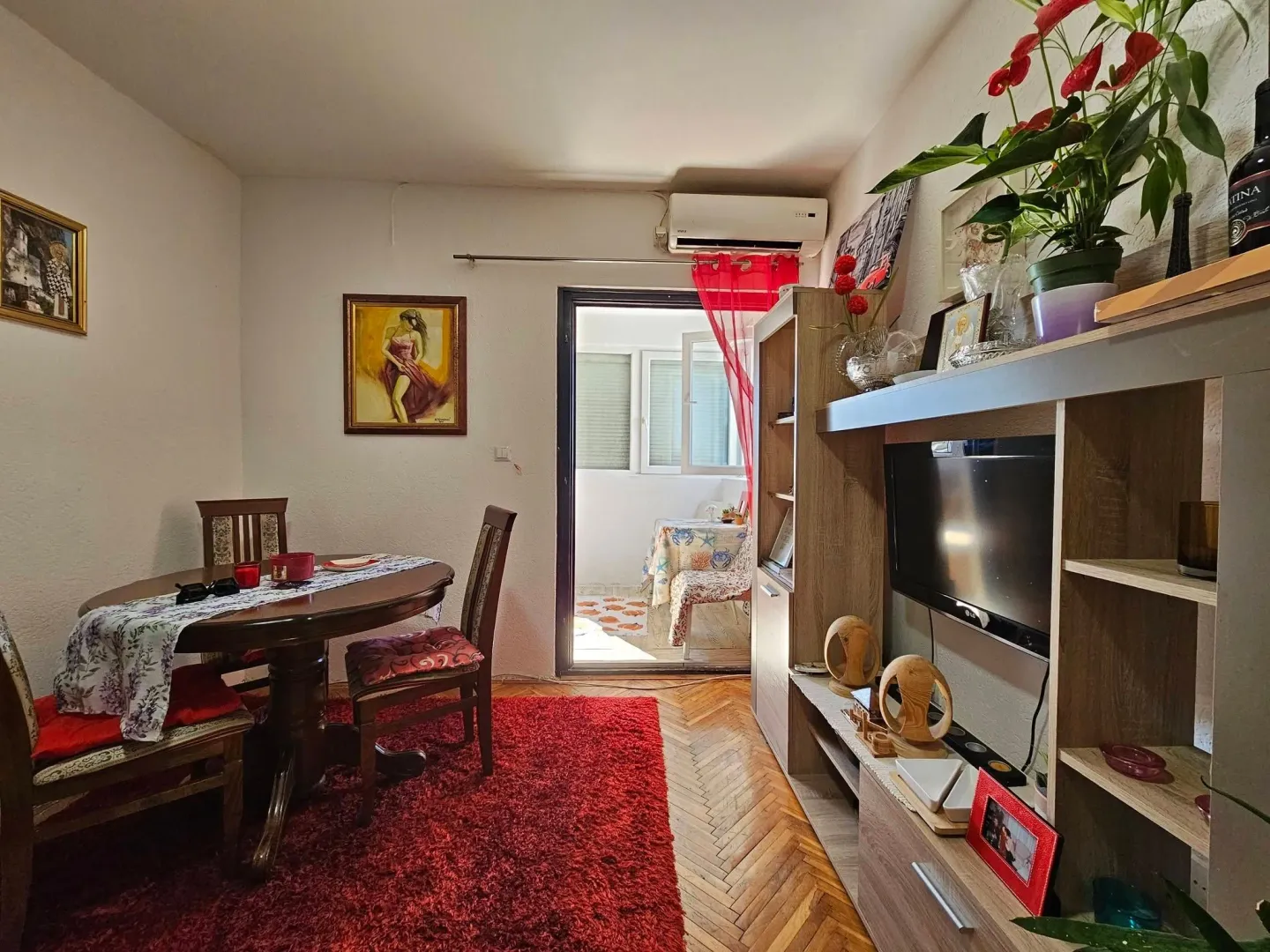 Living room with dining table and television, with access to the terrace.