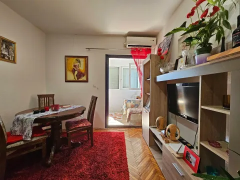 Living room with dining table and television, with access to the terrace. - image 6