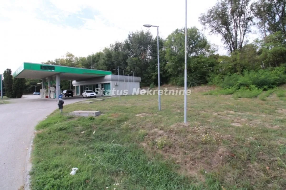 View of the plot and surroundings with a petrol station nearby.