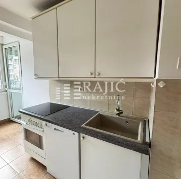 Small kitchen with built-in cabinetry and a sink. - image 10