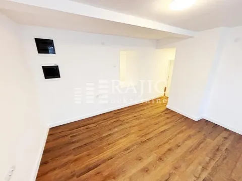 Empty room with laminate flooring and white walls. - image 10