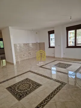 Empty living room with tiled flooring and kitchen installation area. - image 4