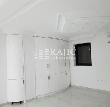 White bedroom with built-in wardrobe and decorative dropped ceiling. - image 2