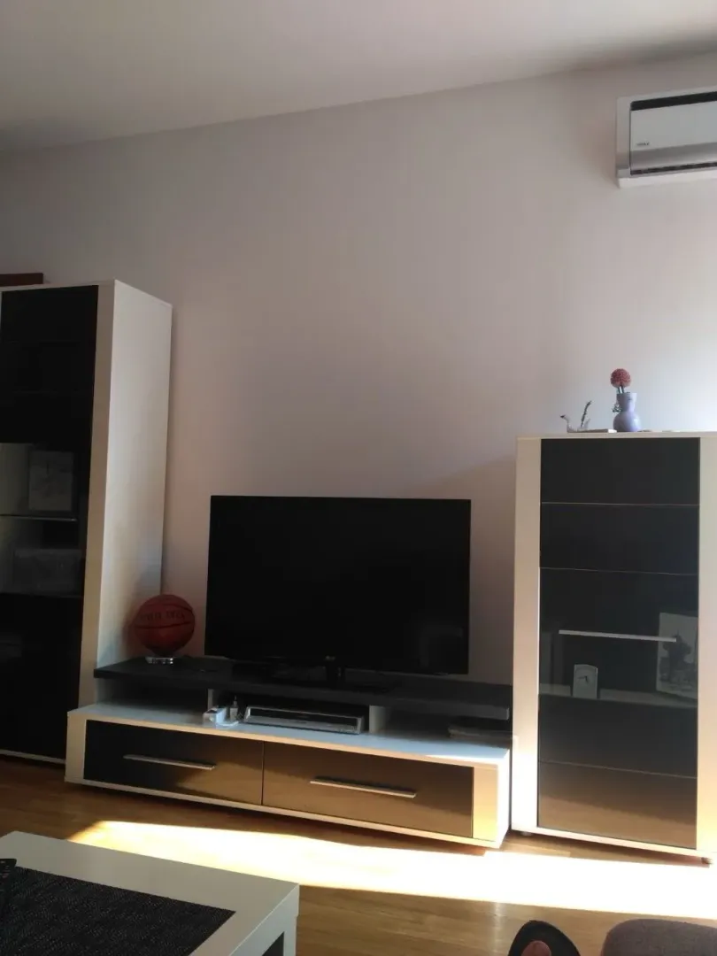 Living room with a TV and a media console.