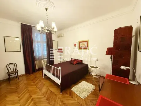 Spacious bedroom with a double bed, wooden flooring, and traditional furniture. - image 4