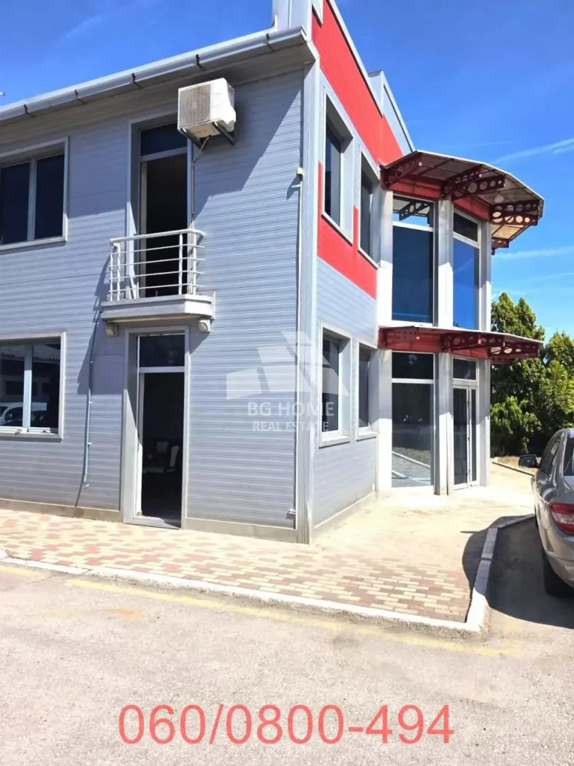 Exterior of the commercial building with a paved yard and parking.