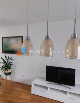 Living room with a white TV unit and pendant lights. - image 3