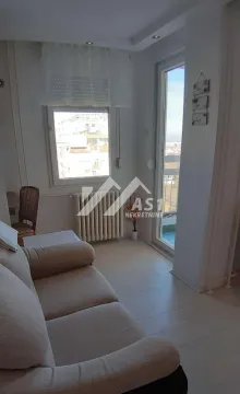 Smaller living room with a sofa and access to the terrace. - image 2